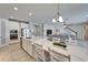 Open concept kitchen and living room with a quartz countertop island and stainless steel appliances at 12851 Tortoise Shell Pl, Riverview, FL 33579