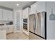 A modern kitchen features stainless steel appliances, white cabinets, and a pantry at 12851 Tortoise Shell Pl, Riverview, FL 33579