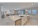 Kitchen with an island featuring bar stool seating with views of the living room and pool at 12851 Tortoise Shell Pl, Riverview, FL 33579