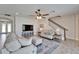 Cozy living room boasts plush seating, a ceiling fan, and a staircase at 12851 Tortoise Shell Pl, Riverview, FL 33579