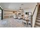 Spacious living room featuring an open floor plan, wood-style tile flooring, and staircase access at 12851 Tortoise Shell Pl, Riverview, FL 33579