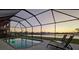 Relax poolside on lounge chairs with a peaceful lake view at sunset at 12851 Tortoise Shell Pl, Riverview, FL 33579