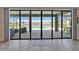 A clear view through sliding glass doors to the lanai, pool, and pond behind the property at 12851 Tortoise Shell Pl, Riverview, FL 33579