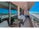 Cozy outdoor balcony seating area with ocean views at 1310 Gulf Blvd # 5C, Clearwater Beach, FL 33767