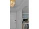 This entryway features a decorative chandelier, white door, and access to the rest of the home at 1310 Gulf Blvd # 5C, Clearwater Beach, FL 33767