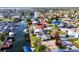 Aerial view of the waterfront home with boat dock and swimming pool at 13633 Britton Dr, Hudson, FL 34667