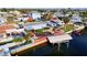 Aerial view of the waterfront home with boat dock and swimming pool at 13633 Britton Dr, Hudson, FL 34667