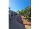Serene backyard featuring winding pathway, tropical landscaping, and a screened patio at 13633 Britton Dr, Hudson, FL 34667
