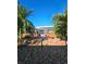 Lush palm trees frame the waterfront view, adding a tropical touch to the serene backyard setting at 13633 Britton Dr, Hudson, FL 34667