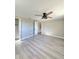 Bright bedroom with ceiling fan and light wood-look laminate flooring at 13633 Britton Dr, Hudson, FL 34667