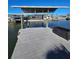 Dock featuring a boat lift, offering easy access to the waterway and enhancing the waterfront lifestyle at 13633 Britton Dr, Hudson, FL 34667