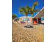 Charming home featuring decorative rocks, palm trees and covered carport, perfect for coastal living at 13633 Britton Dr, Hudson, FL 34667