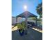Outdoor gazebo with seating surrounded by a fenced yard and mature trees at 13633 Britton Dr, Hudson, FL 34667
