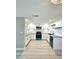 Bright kitchen featuring white cabinets, stainless appliances, and subway tile backsplash at 13633 Britton Dr, Hudson, FL 34667