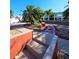 A beautifully landscaped yard with palm trees and stone walkway leading to glass enclosed porch at 13633 Britton Dr, Hudson, FL 34667