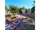 Lush landscaping features decorative rocks and tropical plants, with a stone bench at 13633 Britton Dr, Hudson, FL 34667