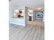 Open living room with eat-in kitchen featuring white cabinetry and modern backsplash at 13633 Britton Dr, Hudson, FL 34667