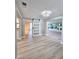 Open-concept living area featuring sliding barn door and bright windows at 13633 Britton Dr, Hudson, FL 34667