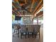Outdoor bar area with seating, a stone backsplash, and a ceiling fan at 13633 Britton Dr, Hudson, FL 34667