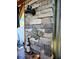 Cozy outdoor bar showcasing stone wall, stylish light fixture, and quirky fish mosaic art at 13633 Britton Dr, Hudson, FL 34667
