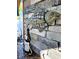 Stylish outdoor bar area featuring a stone wall with unique fish mosaic art at 13633 Britton Dr, Hudson, FL 34667