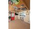 Enclosed patio with tongue-and-groove ceiling, fan, TV, seating, and outdoor cooking space at 13633 Britton Dr, Hudson, FL 34667