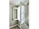 Window with white shutter, enhancing both the aesthetics and functionality of the interior space at 13633 Britton Dr, Hudson, FL 34667