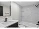 Modern bathroom features a sleek vanity, updated shower and tub with decorative tiling at 13969 Gull Way, Clearwater, FL 33762