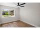 Bright bedroom featuring Luxury Vinyl Plank flooring and large, sunlit window at 13969 Gull Way, Clearwater, FL 33762