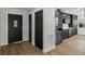 Welcoming entryway featuring modern fixtures, black doors and luxury vinyl plank flooring at 13969 Gull Way, Clearwater, FL 33762