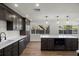 Modern kitchen featuring dark wood cabinets, stainless appliances, and white countertops at 13969 Gull Way, Clearwater, FL 33762