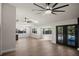 Spacious living room featuring hardwood floors, natural light, and backyard access at 13969 Gull Way, Clearwater, FL 33762
