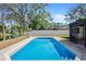 Inviting pool surrounded by brick pavers and lush landscaping, perfect for outdoor enjoyment at 13969 Gull Way, Clearwater, FL 33762