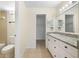 Bright bathroom featuring a vanity with granite countertop and modern fixtures at 14130 Rosemary Ln # 5206, Largo, FL 33774
