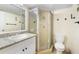 Bathroom featuring white vanity, granite countertops, and glass enclosed shower at 14130 Rosemary Ln # 5206, Largo, FL 33774