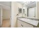 Bathroom with granite countertop and vanity plus large mirror at 14130 Rosemary Ln # 5206, Largo, FL 33774