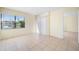 Cozy bedroom with tile flooring, sliding glass door, and a window offering natural light at 14130 Rosemary Ln # 5206, Largo, FL 33774