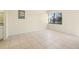 This bedroom features tile flooring and large window providing ample natural light at 14130 Rosemary Ln # 5206, Largo, FL 33774