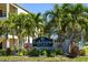Entrance to the Lakeview of Largo community, with mature palm trees and landscaping at 14130 Rosemary Ln # 5206, Largo, FL 33774