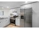 A modern kitchen featuring white cabinets, stainless steel appliances, and stylish granite countertops at 14130 Rosemary Ln # 5206, Largo, FL 33774