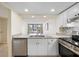 Bright kitchen with granite countertops, stainless steel appliances, and updated cabinetry at 14130 Rosemary Ln # 5206, Largo, FL 33774