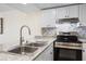 Updated kitchen showcasing stainless steel appliances, granite countertops and tile backsplash at 14130 Rosemary Ln # 5206, Largo, FL 33774