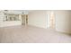 A spacious living room featuring tile flooring, connecting the kitchen, bath, and bedroom at 14130 Rosemary Ln # 5206, Largo, FL 33774