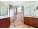 Updated bathroom features a large glass shower, dual sinks, and modern fixtures at 16145 Amethyst Key Dr, Wimauma, FL 33598