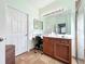 Bathroom featuring vanity with a granite counter, large mirror, and walk-in shower at 16145 Amethyst Key Dr, Wimauma, FL 33598