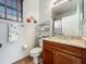 Bathroom featuring wooden cabinets, granite countertop, mirror, and decorative accents at 16145 Amethyst Key Dr, Wimauma, FL 33598