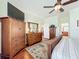 This is a spacious bedroom with hardwood floors and a big dresser with a mirror on top at 16145 Amethyst Key Dr, Wimauma, FL 33598
