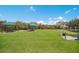 Large fenced dog park with green grass and shaded picnic areas for residents to enjoy at 16145 Amethyst Key Dr, Wimauma, FL 33598
