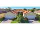 Beautiful single-story home with a well-manicured lawn, lush landscaping, brick driveway, and two-car garage at 16145 Amethyst Key Dr, Wimauma, FL 33598