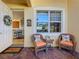 Inviting covered porch with seating, a welcome mat, and an open entry into the home at 16145 Amethyst Key Dr, Wimauma, FL 33598